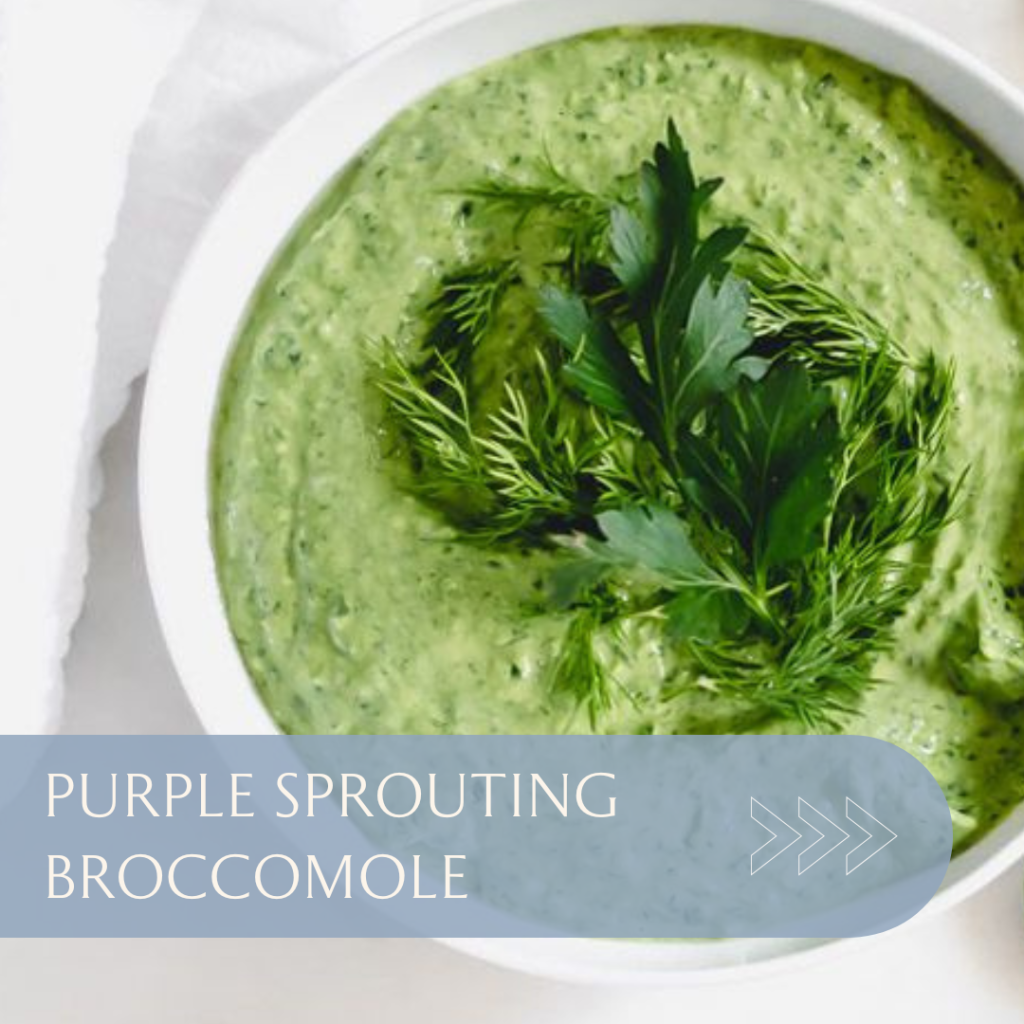 Bowl of purple sprouting broccomole garnished with fresh herbs, showcasing a vibrant green colour and creamy texture.