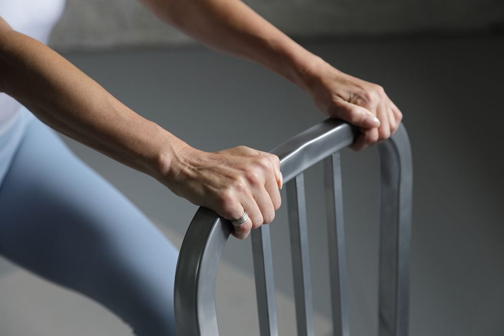 Close-up of hands gripping a metal exercise bar during a workout session.