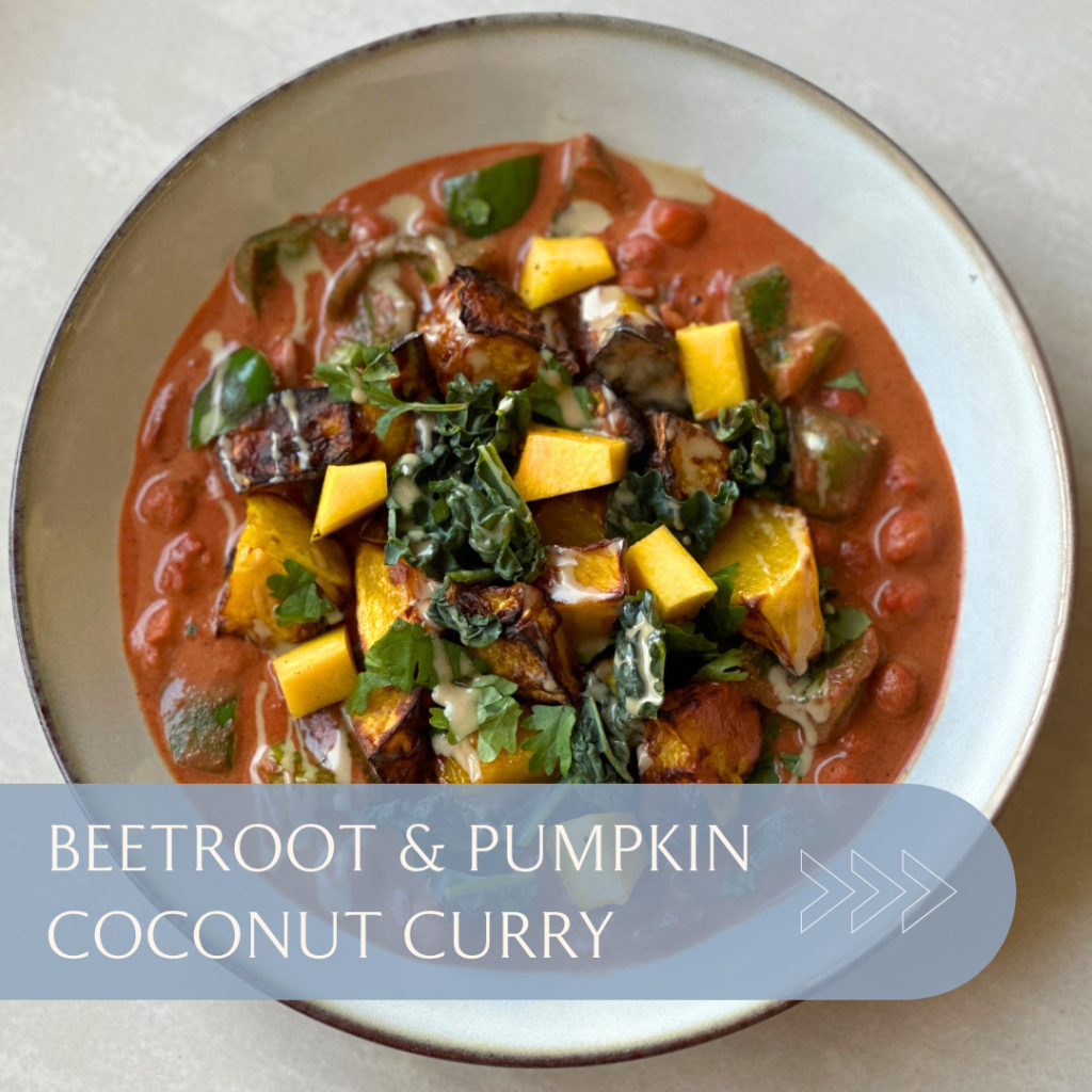 Bowl of beetroot and pumpkin coconut curry with various vegetables and herbs arranged attractively.