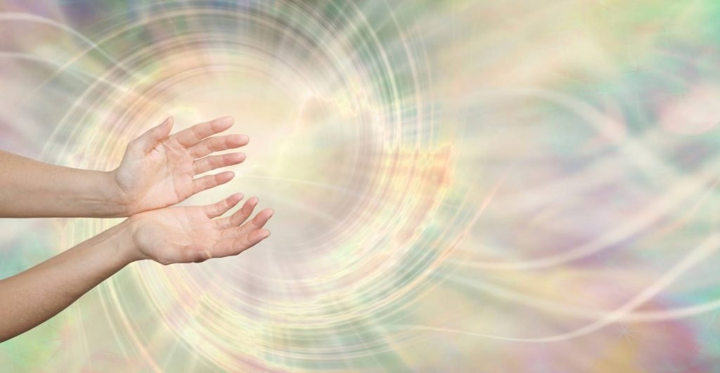 Hands reaching out with a soft, swirling background in pastel colours, conveying a sense of openness and connection. 1 High.